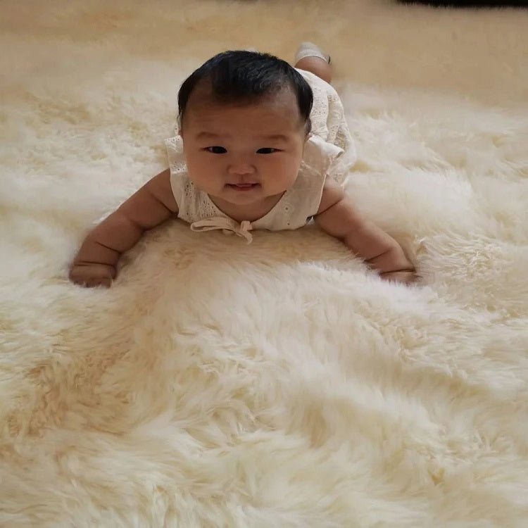Light-colored Woolous sheepskin rug used as a breathable summer home decor accent.